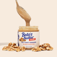 GIF of a spoon scooping a spoonful of Beto's Butter from the jar with walnuts scattered around the jar